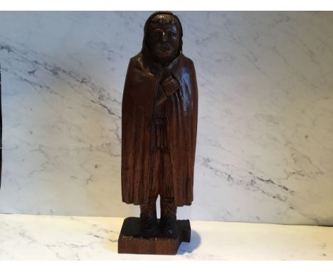 A 19th century hardwood carving, of a bearded man, wearing a hood cloak, 41cm high, c.1880 