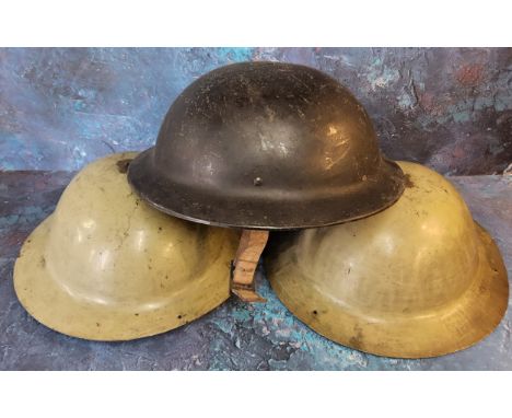 A World War II Plasfort helmet;&nbsp; others, tin (3) 