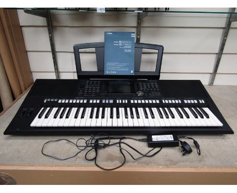 A Yamaha PSR-S950 electronic keyboard, with manual