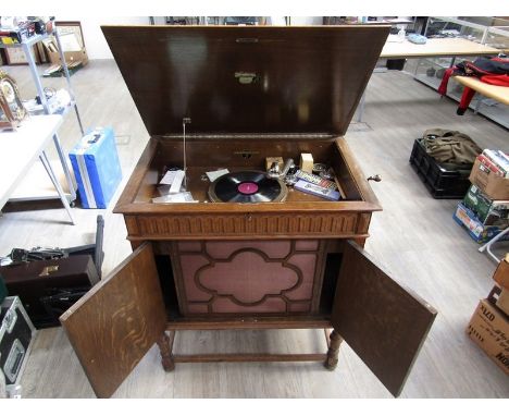 A Columbia oak cased cabinet gramophone with twin panelled doors housing speaker (water damage to cabinet) 