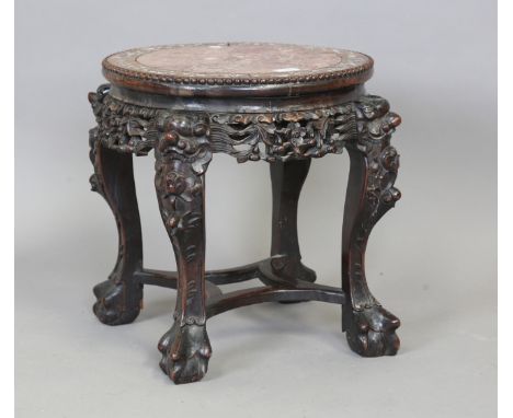 A Chinese hardwood stand, late 19th century, the circular top inset with a rouge marble panel within a mother-of-pearl inlaid