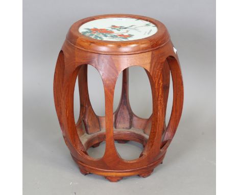 A Chinese hardwood and porcelain mounted garden seat/stand, 20th century, of openwork barrel form, the top inset with a porce