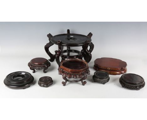 A collection of eight Chinese and Japanese wood stands, late 19th century and later, including a Chinese octagonal hardwood s
