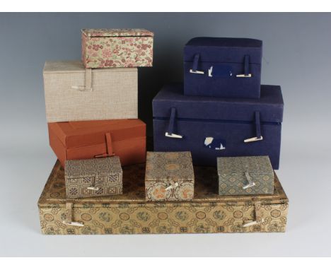 A Chinese silk mounted rectangular snuff bottle display box, mid-20th century, the hinged lid revealing twenty compartments, 