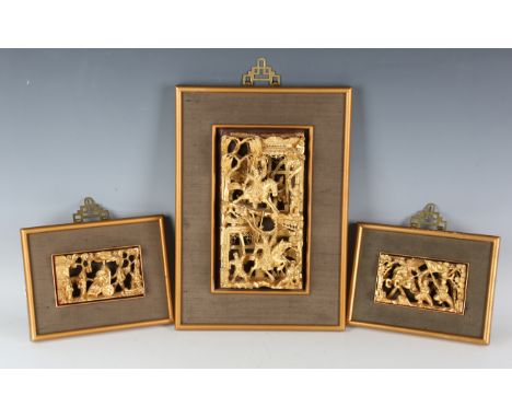 A Chinese carved and pierced giltwood rectangular panel, early 20th century, decorated in high relief with warriors battling 