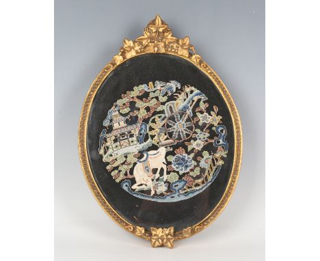 A Chinese embroidered oval panel, late 19th/early 20th century, worked in polychrome and gilt threads with a scene of horse a
