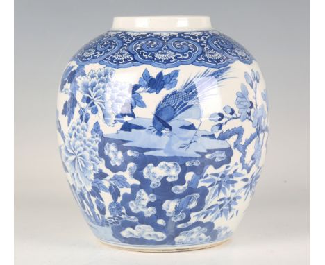 A Chinese blue and white porcelain ginger jar, mark of Kangxi but late 19th century, the stout ovoid body painted with a phea