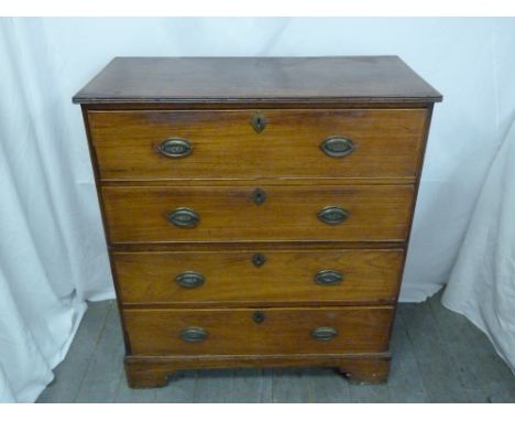 A mahogany four drawer campaign chest of drawers with brass handles on four bracket feet