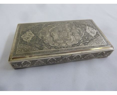 A Persian rectangular white metal cigarette box engraved with figures, birds and animals on four bracket feet