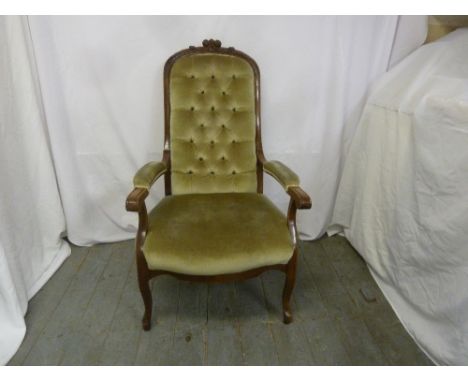 A Victorian mahogany upholstered ladies button back armchair on four cabriole legs