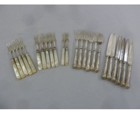 A quantity of silver and mother of pearl dessert forks and a set of six fish eaters with filled silver handles