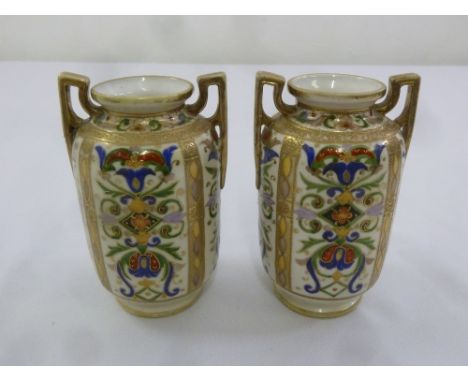 A pair of Noritake two handled vases with polychromatic geometric motifs and gilding