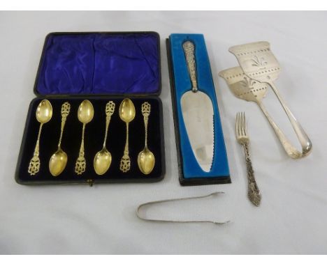 A quantity of silver to include a cased set of teaspoons, a cake slice, a pair of asparagus tongs, a pair of tongs and a cake