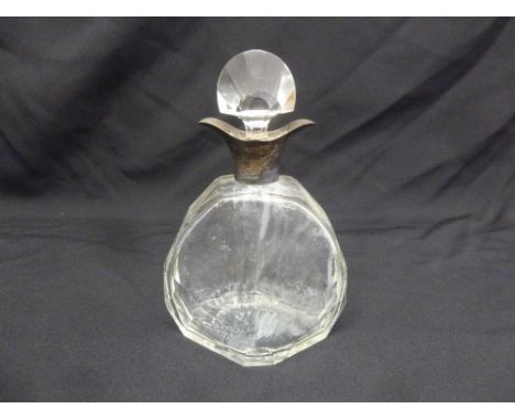A glass decanter shaped oval with silver collar and drop stopper