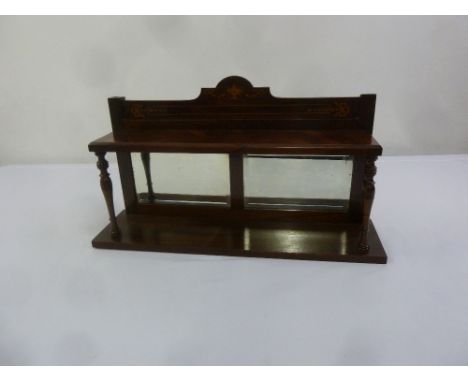 An Edwardian rectangular mahogany mirror backed wall shelf