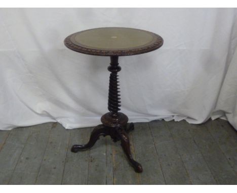 A Victorian mahogany circular wine table with tooled leather top with twist stem on tripod base