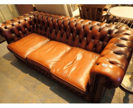 Chesterfield three seat red leather settee with button back and arms  CONDITION REPORT: Considerably amount of use wear scrat