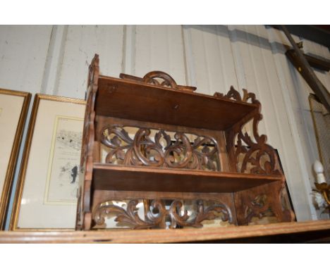 A small Victorian carved wooden two tier folding shelf