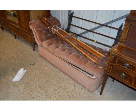 A brown upholstered button down ottoman 