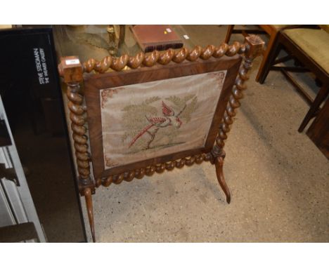 A Victorian mahogany firescreen raised on barley twist columns