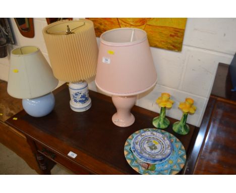 Three various table lamp bases together with a pair of floral candlesticks; and three various plates 