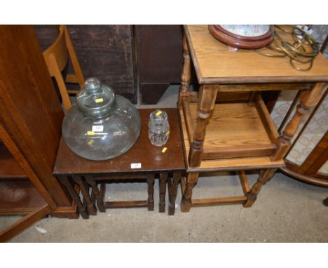Two light oak lamp tables; and a nest of three oak occasional tables 