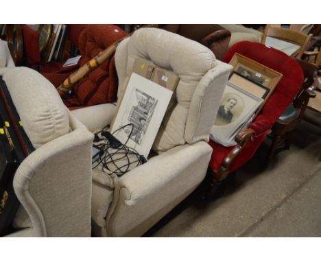 An upholstered button back electrical reclining armchair