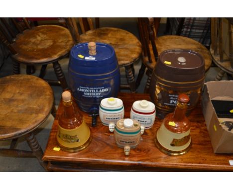 Two large spirit barrels; three smaller and two Bells Scotch whiskey decanters 