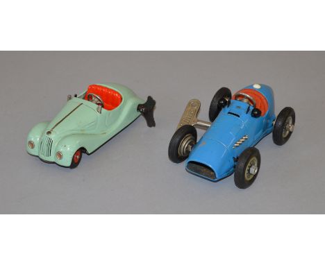 Two Schuco models: 1070 Grand Prix Racer in blue with key, racing number 1, windshield and one hubcap missing; Akustico 2002 