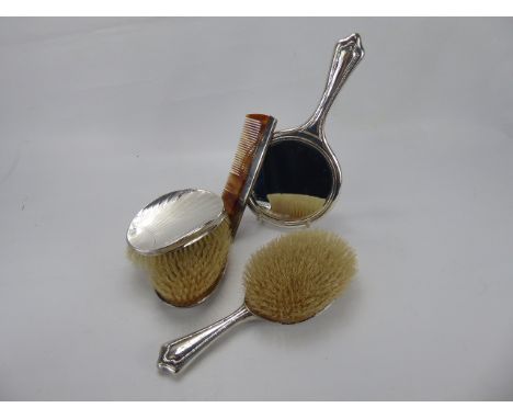 A Lady's Silver Dressing Table Set, comprising hairbrush, double hair brush, mirror and comb, Sheffield hallmark and Birmingh