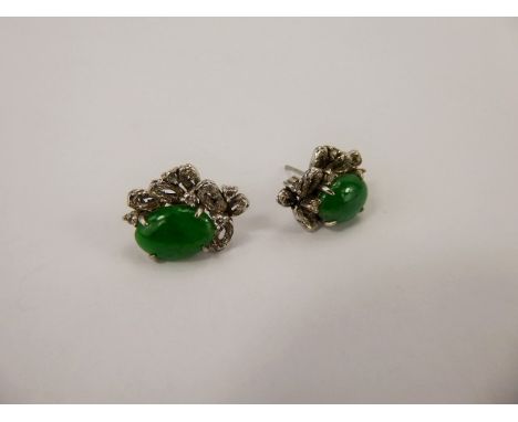 A Pair of 18 ct White Gold Diamond and Green Jade Earrings, the earrings each set with five dias and measuring approx 18 x 9 
