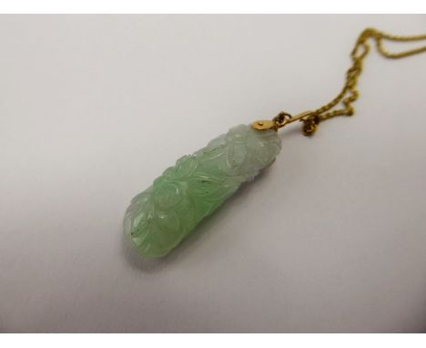 A Chinese White and Green Jade Flower Carved Pendant on 18 ct chain, approx wt. of chain and loop 3 gms, total approx wt. 9.7