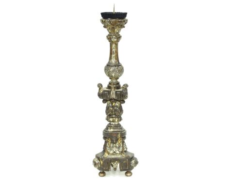 A pricket altar type candlestick of Carolean design on three brass feet, 86cm high