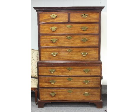 A George III mahogany chest on chest, with dentil cornice above two short and three long drawers on a chest with brushing sli