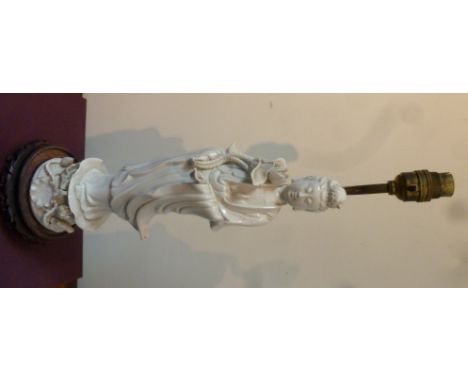 A Chinese blanc-de-chine figure of Guanyin standing holding a lotus flower, converted to a lamp, 36cm high