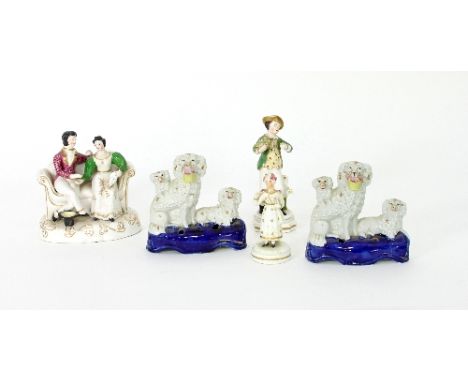 Two pen stands, each with two poodles and a puppy, 13.5cm high, two Staffordshire figures and a Staffordshire type group of a