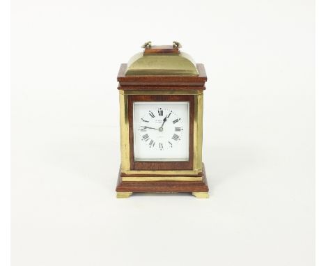 A late 19th Century mahogany brass mounted eight-day carriage clock, the case with bell top and fitted a white enamel dial wi