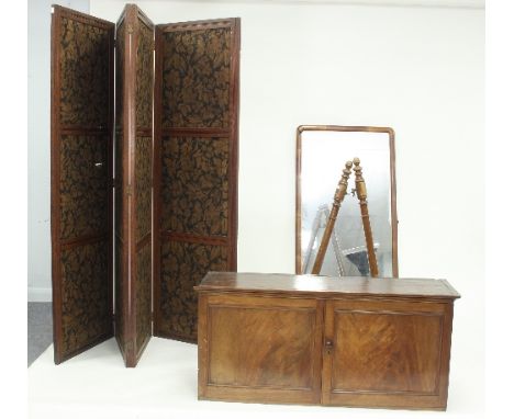 A mahogany cupboard enclosed by panel doors, 101cm wide, a Victorian cheval mirror (distressed) and an Edwardian four-fold sc