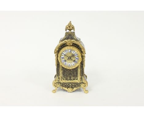 A 19th Century tortoiseshell and brass eight-day boulle type mantel clock, the gilded dial with segmented enamel chapter ring