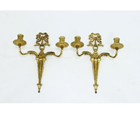 A pair of gilt metal two-light wall lights hung from ribbon-tied bows, 37cm high Condition Report: Slight rubbing to gilt, so