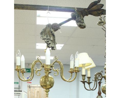 A Dutch brass six-light chandelier with scroll branches and the tasselled tie for the same, 124cm high