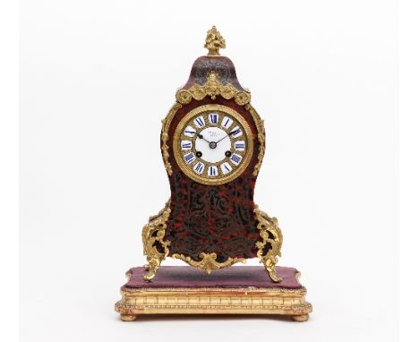 A 19th Century French tortoiseshell and brass boulle type eight-day mantel clock, with gilt metal basket of flowers finial an