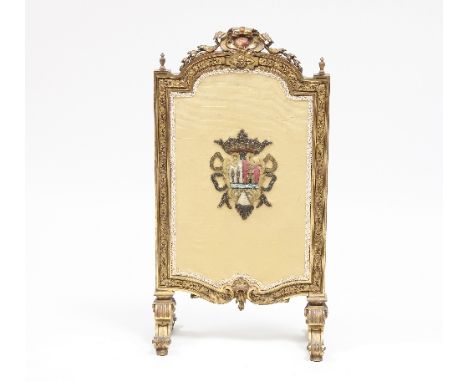 A carved and gilded fire screen, sewn with armorials, 71cm high