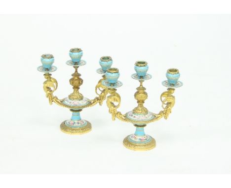 A pair of 19th Century ormolu porcelain moulded two-branch three-light table lights with hinged caryatid branches, the mounts