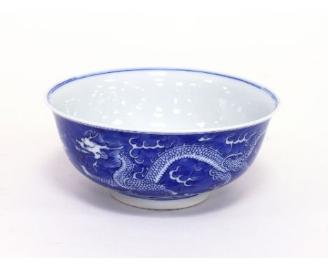 A Chinese blue and white dragon bowl, bearing apocryphal Kangxi marks, 16.25cm diameter Condition Report: Overall in good con