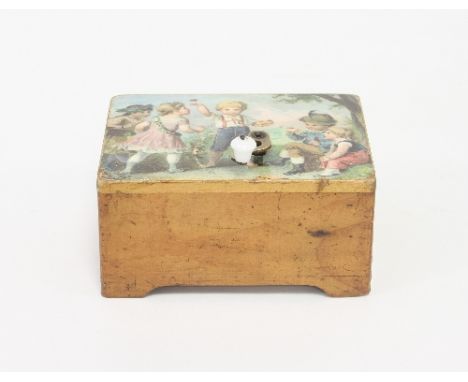 A child's hand cranked musical box, transfer printed a scene of children playing with bees, 12cm wide