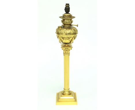 A brass Corinthian column oil lamp with embossed well (converted for electricity), with shade, 77.5cm high