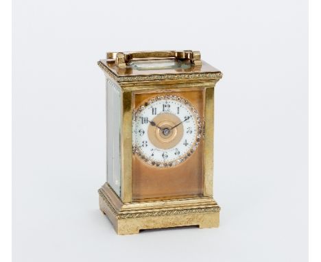 A late 19th Century gilt brass eight-day carriage clock, the case with rope borders, the cream enamel chapter ring with Arabi