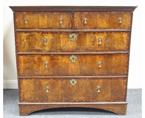 A George I walnut chest fitted three long and two short drawers, cross banded and with brass drop handles and keyhole escutch