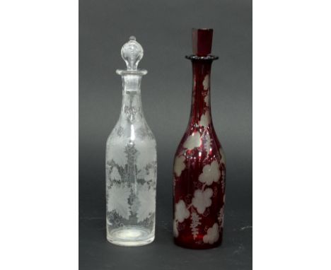 A Bohemian ruby glass decanter engraved grapes and vines with stopper, 36cm high and a clear glass decanter and stopper, engr